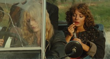 Movie still from “City of Women” (1980), directed by Federico Fellini – A woman putting lipstick on while sitting in a car; Medium shot, Over the shoulder angle
