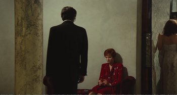 Movie still from “City of Women” (1980), directed by Federico Fellini – A man and a woman sitting in a red chair; Medium shot, Over the shoulder angle
