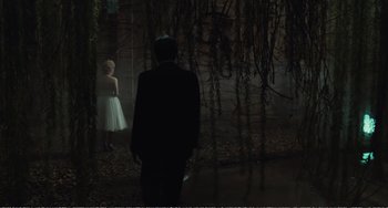 Movie still from “City of Women” (1980), directed by Federico Fellini – A man and a woman standing in front of a wall; Wide shot, Over the shoulder angle