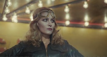 Movie still from “City of Women” (1980), directed by Federico Fellini – A woman wearing a leather jacket and goggles looking to her left; Medium shot, Low angle