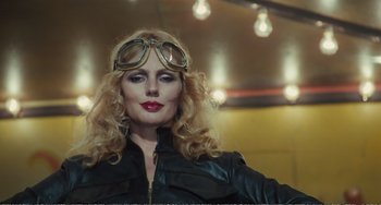 Movie still from “City of Women” (1980), directed by Federico Fellini – A woman wearing goggles and a leather jacket; Close Up shot, Low angle