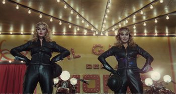 Movie still from “City of Women” (1980), directed by Federico Fellini – A couple of women standing next to each other; Medium shot, Low angle