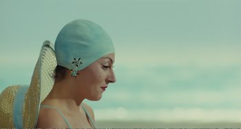 Movie still from “City of Women” (1980), directed by Federico Fellini – A person wearing a swim cap; Close Up shot, Over the shoulder angle