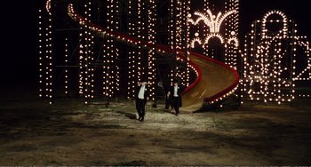 Movie still from “City of Women” (1980), directed by Federico Fellini – Two people in black and white suits walking in the dark; Extreme Wide shot, High angle