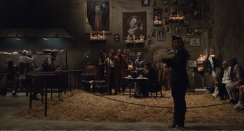 Movie still from “City of Women” (1980), directed by Federico Fellini – A group of people sitting in a living room with candles; Wide shot, High angle