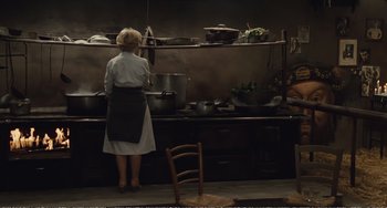 Movie still from “City of Women” (1980), directed by Federico Fellini – A woman standing in front of a kitchen sink; Wide shot, High angle