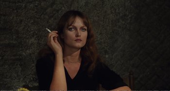 Movie still from “City of Women” (1980), directed by Federico Fellini – A woman holding a cigarette in her hand; Close Up shot, Over the shoulder angle