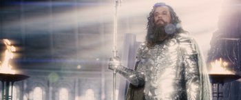 Movie still from “Clash of the Titans” (2010), directed by Louis Leterrier – A man dressed in armor and holding a sword; Medium shot, Low angle