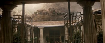 Movie still from “Clash of the Titans” (2010), directed by Louis Leterrier – A view of a building with a mountain in the background; Extreme Wide shot, High angle