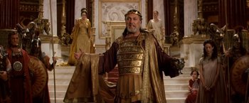 Movie still from “Clash of the Titans” (2010), directed by Louis Leterrier – A man wearing a crown standing in front of two other women; Medium shot, Low angle