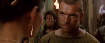 Movie still from “Clash of the Titans” (2010), directed by Louis Leterrier – A person in a room with other people; Close Up shot, Over the shoulder angle