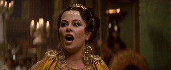 Movie still from “Clash of the Titans” (2010), directed by Louis Leterrier – A woman in a gold dress and gold jewelry; Close Up shot, Low angle