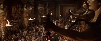 Movie still from “Clash of the Titans” (2010), directed by Louis Leterrier – A crowd of people gathered in a large room; Wide shot, High angle