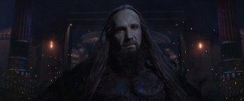 Movie still from “Clash of the Titans” (2010), directed by Louis Leterrier – A man with long hair and a long beard; Close Up shot, Over the shoulder angle