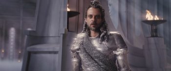 Movie still from “Clash of the Titans” (2010), directed by Louis Leterrier – A man dressed in a metal armor and holding a sword; Close Up shot, Low angle