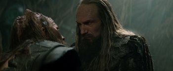 Movie still from “Clash of the Titans” (2010), directed by Louis Leterrier – A man with long hair and a long beard is looking at another man with long hair and a long beard; Close Up shot, Over the shoulder angle