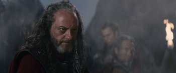 Movie still from “Clash of the Titans” (2010), directed by Louis Leterrier – A person with long hair and a beard; Close Up shot, Over the shoulder angle