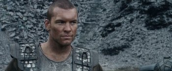 Movie still from “Clash of the Titans” (2010), directed by Louis Leterrier – A person wearing a body armor; Close Up shot, Over the shoulder angle