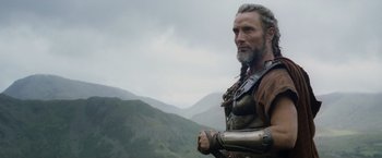 Movie still from “Clash of the Titans” (2010), directed by Louis Leterrier – A man with a beard and a long beard is wearing armor; Close Up shot, Low angle