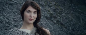 Movie still from “Clash of the Titans” (2010), directed by Louis Leterrier – A beautiful woman with long brown hair posing for a picture; Close Up shot, Over the shoulder angle