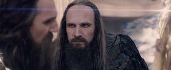 Movie still from “Clash of the Titans” (2010), directed by Louis Leterrier – A man with long hair and a long beard; Close Up shot, Over the shoulder angle