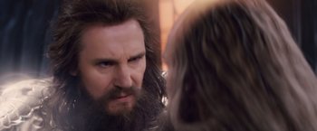 Movie still from “Clash of the Titans” (2010), directed by Louis Leterrier – A man with long hair and a beard looking at another man with long hair; Close Up shot, Over the shoulder angle