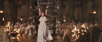 Movie still from “Clash of the Titans” (2010), directed by Louis Leterrier – A woman in a white dress holding onto a rope; Wide shot, High angle
