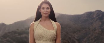 Movie still from “Clash of the Titans” (2010), directed by Louis Leterrier – A woman in a white dress standing in front of a mountain; Close Up shot, Low angle