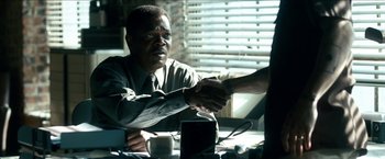 Movie still from “Cleaner” (2007), directed by Renny Harlin – Two people shaking hands over a table in front of a window; Close Up shot, Over the shoulder angle