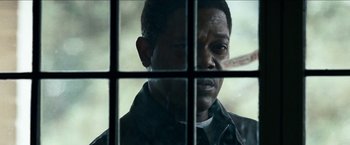 Movie still from “Cleaner” (2007), directed by Renny Harlin – A person behind a window; Close Up shot, Over the shoulder angle