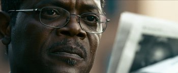 Movie still from “Cleaner” (2007), directed by Renny Harlin – A man's face wearing glasses; Extreme Close Up shot, Low angle