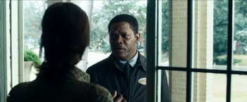 Movie still from “Cleaner” (2007), directed by Renny Harlin – A man standing next to a woman in front of a window; Close Up shot, Over the shoulder angle