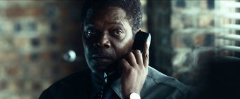 Movie still from “Cleaner” (2007), directed by Renny Harlin – A man talking on a cell phone; Close Up shot, Low angle