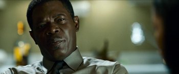 Movie still from “Cleaner” (2007), directed by Renny Harlin – A person wearing a shirt and tie; Close Up shot, Over the shoulder angle