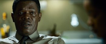 Movie still from “Cleaner” (2007), directed by Renny Harlin – A person wearing a shirt and tie; Close Up shot, Over the shoulder angle