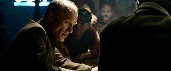 Movie still from “Cleaner” (2007), directed by Renny Harlin – An older man sitting in front of a group of young men; Close Up shot, Over the shoulder angle