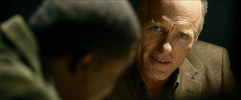 Movie still from “Cleaner” (2007), directed by Renny Harlin – An older man with blue eyes looking at a younger man; Extreme Close Up shot, Over the shoulder angle