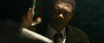 Movie still from “Cleaner” (2007), directed by Renny Harlin – A man in a suit and a tie; Close Up shot, Over the shoulder angle