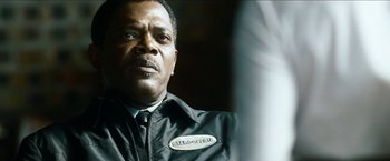 Movie still from “Cleaner” (2007), directed by Renny Harlin – A person wearing a black jacket; Close Up shot, Over the shoulder angle