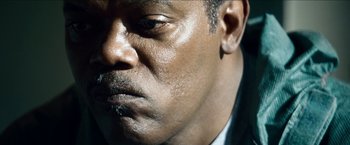 Movie still from “Cleaner” (2007), directed by Renny Harlin – A man's face in a black suit; Extreme Close Up shot, Low angle
