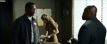 Movie still from “Cleaner” (2007), directed by Renny Harlin – A man and a woman standing in front of a window; Medium shot, Over the shoulder angle