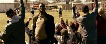 Movie still from “Cleaner” (2007), directed by Renny Harlin – A man standing in front of a group of people; Medium shot, Low angle