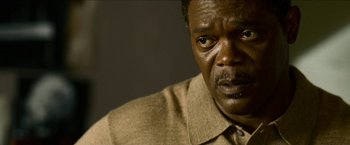 An older black man looking at the camera