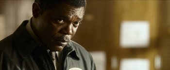 Movie still from “Cleaner” (2007), directed by Renny Harlin – A person wearing a suit and tie; Close Up shot, Low angle