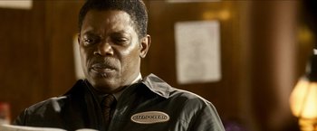 Movie still from “Cleaner” (2007), directed by Renny Harlin – A person wearing a jacket and a tie; Close Up shot, Low angle