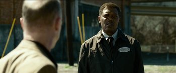 Movie still from “Cleaner” (2007), directed by Renny Harlin – A man wearing a black jacket and a white tie; Close Up shot, Over the shoulder angle