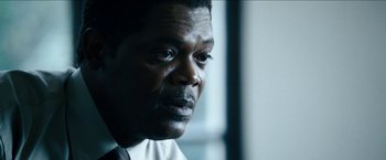 Movie still from “Cleaner” (2007), directed by Renny Harlin – A person wearing a suit and tie; Close Up shot, Low angle