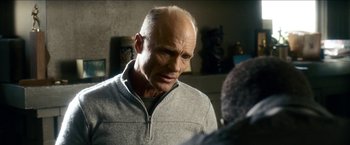 Movie still from “Cleaner” (2007), directed by Renny Harlin – An older bald man is looking into the mirror; Close Up shot, Over the shoulder angle