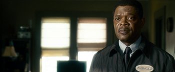 Movie still from “Cleaner” (2007), directed by Renny Harlin – A person wearing a suit and tie; Close Up shot, Low angle