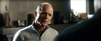 Movie still from “Cleaner” (2007), directed by Renny Harlin – An older man is looking into the camera; Close Up shot, Over the shoulder angle